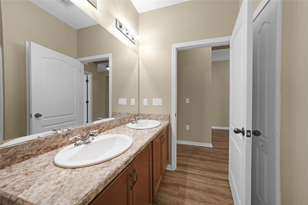 10147 Winding River Road Punta Gorda, FL 33950 - Photo 23 of 33 a bathroom with a sink double vanity granite and a mirror