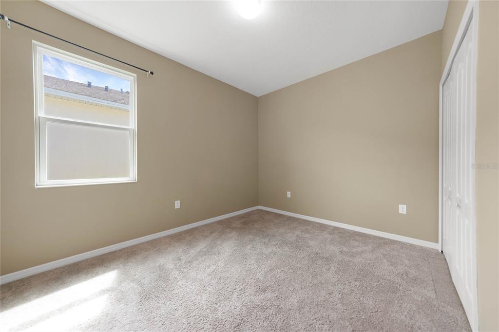 10147 Winding River Road Punta Gorda, FL 33950 - Photo 26 of 33 a view of an empty room with closet and a window
