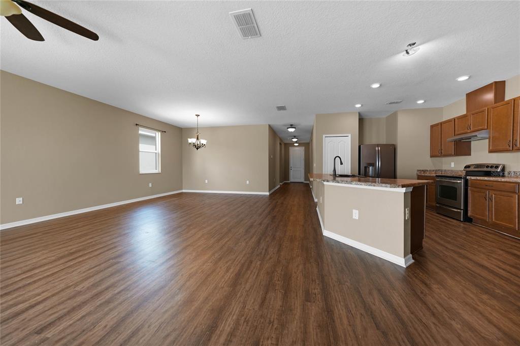 10147 Winding River Road Punta Gorda, FL 33950 - Photo 4 of 33 a large kitchen with stainless steel appliances granite countertop a large counter top a wooden floors and a large window