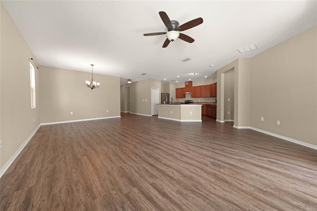 10147 Winding River Road Punta Gorda, FL 33950 - Photo 5 of 33 wooden floor in an empty room with a kitchen