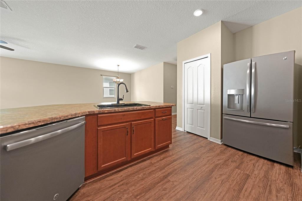 10147 Winding River Road Punta Gorda, FL 33950 - Photo 9 of 33 a kitchen with stainless steel appliances granite countertop a refrigerator a sink and wooden cabinets