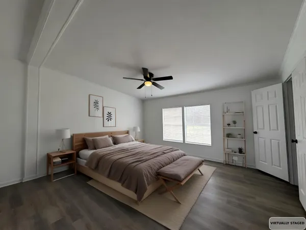 a bedroom with a bed and a ceiling fan