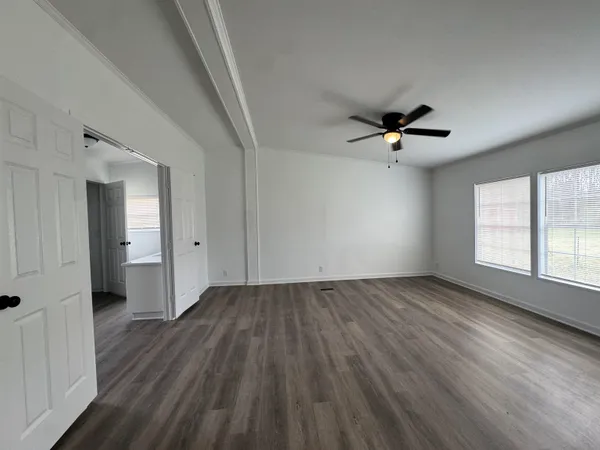 a view of a livingroom with a hardwood floor and a ceiling fan