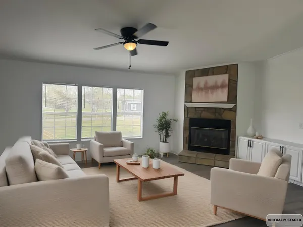 a living room with furniture and a fireplace