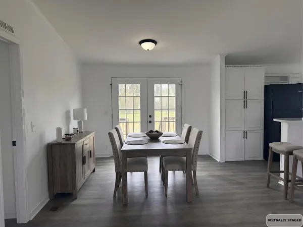 a view of a dining room with furniture and a window