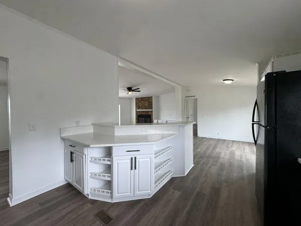 a kitchen with a refrigerator and a stove top oven
