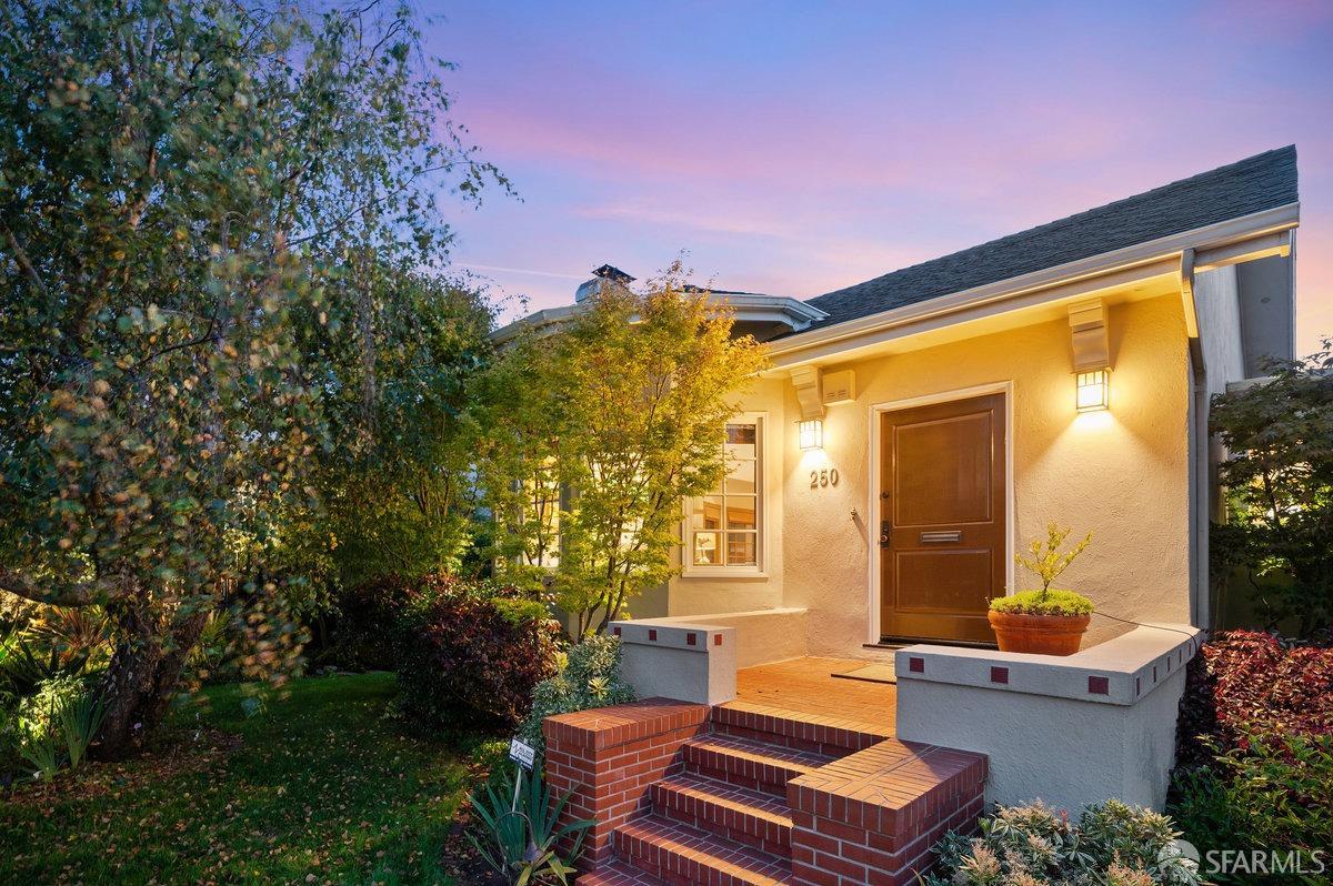 a backyard of a house with fountain table and chairs