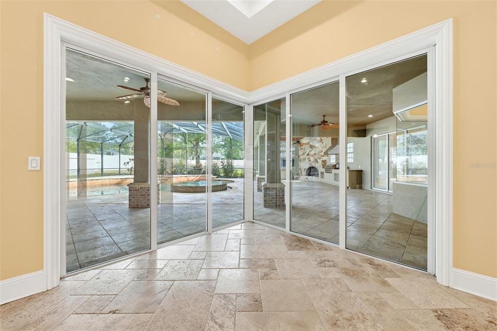 30248 Rainey Road Sorrento, FL 32776 - Photo 12 of 64 a empty room with floor to ceiling windows and glass door