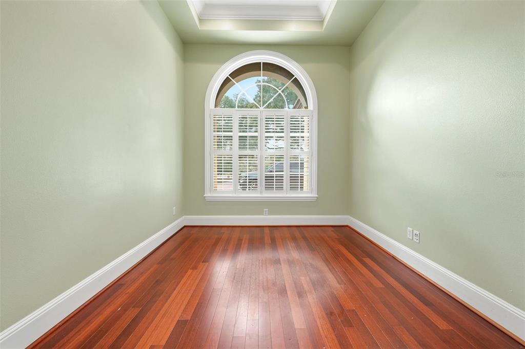 30248 Rainey Road Sorrento, FL 32776 - Photo 17 of 64 an empty room with wooden floor and windows