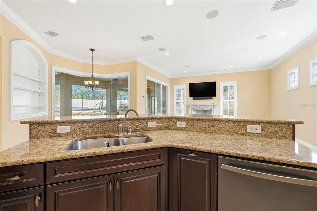 30248 Rainey Road Sorrento, FL 32776 - Photo 24 of 64 a kitchen with granite countertop a sink and a white wooden cabinets