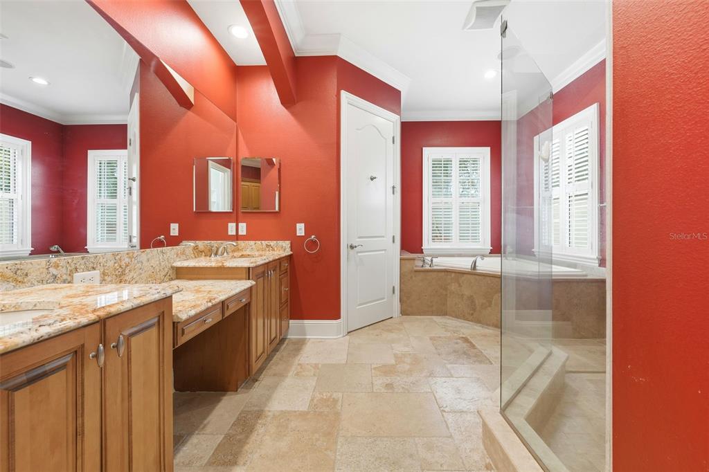 30248 Rainey Road Sorrento, FL 32776 - Photo 35 of 64 a bathroom with a granite countertop sink and mirror with bathtub