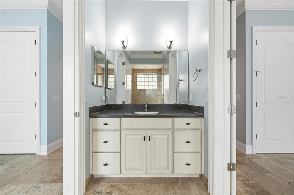 30248 Rainey Road Sorrento, FL 32776 - Photo 42 of 64 a bathroom with a granite countertop sink two mirror and a large mirror