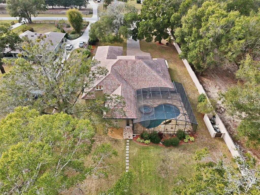 30248 Rainey Road Sorrento, FL 32776 - Photo 59 of 64 a aerial view of a house with swimming pool and lawn chairs