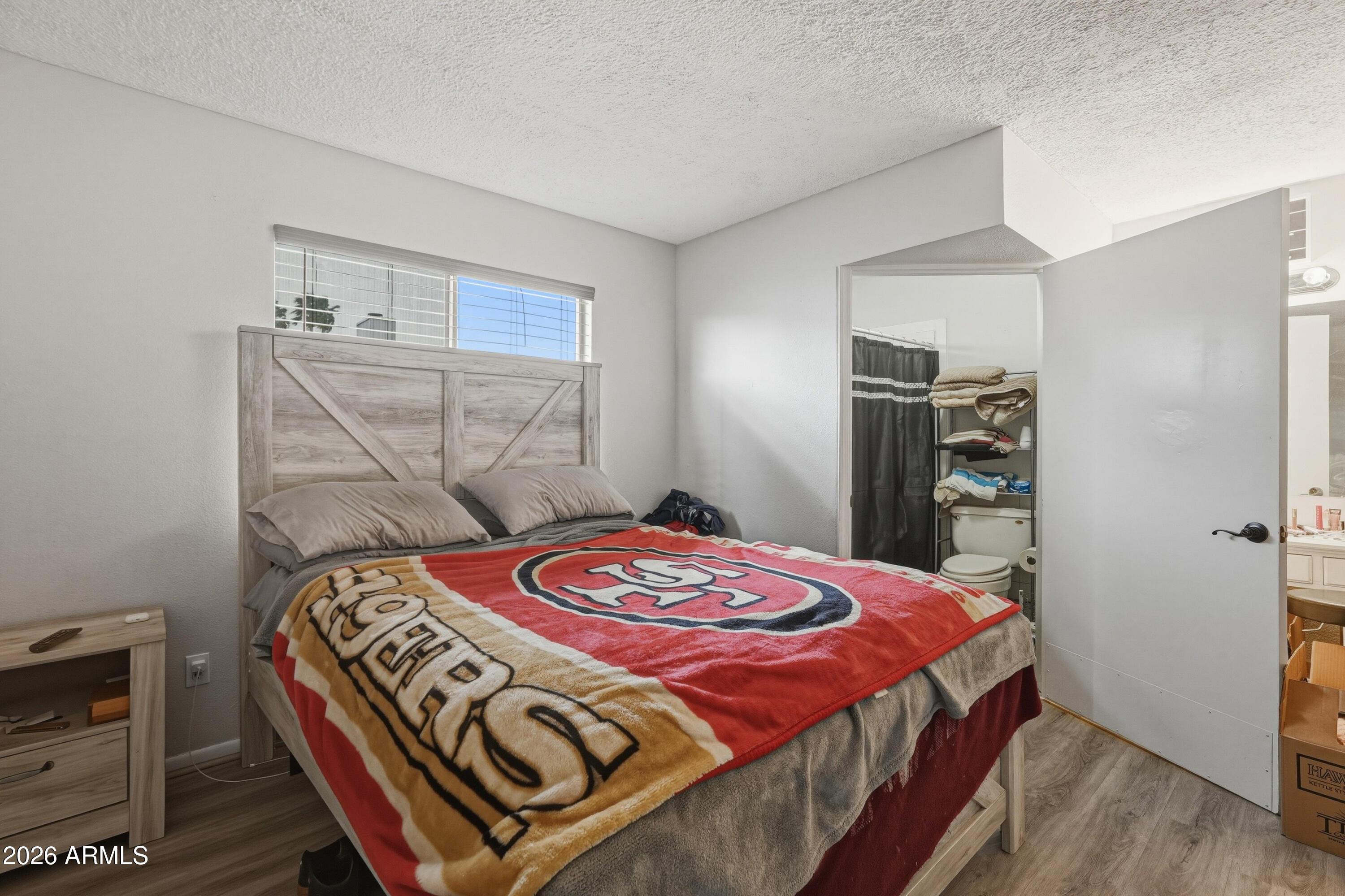7233 West Hatcher Road Peoria, AZ 85345 - Photo 14 of 36 a bedroom with a bed and a closet