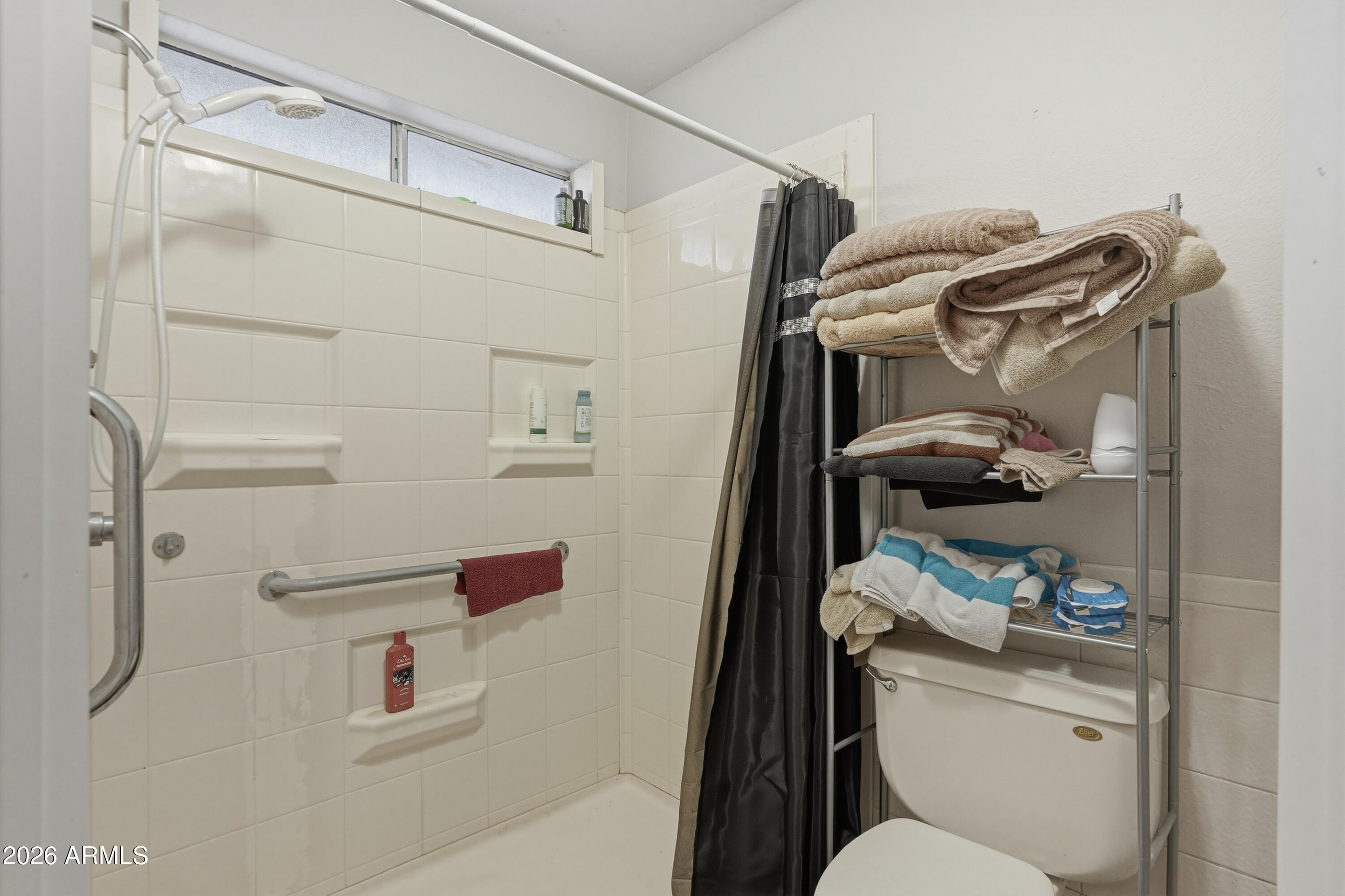7233 West Hatcher Road Peoria, AZ 85345 - Photo 17 of 36 a bathroom with a toilet and a shower