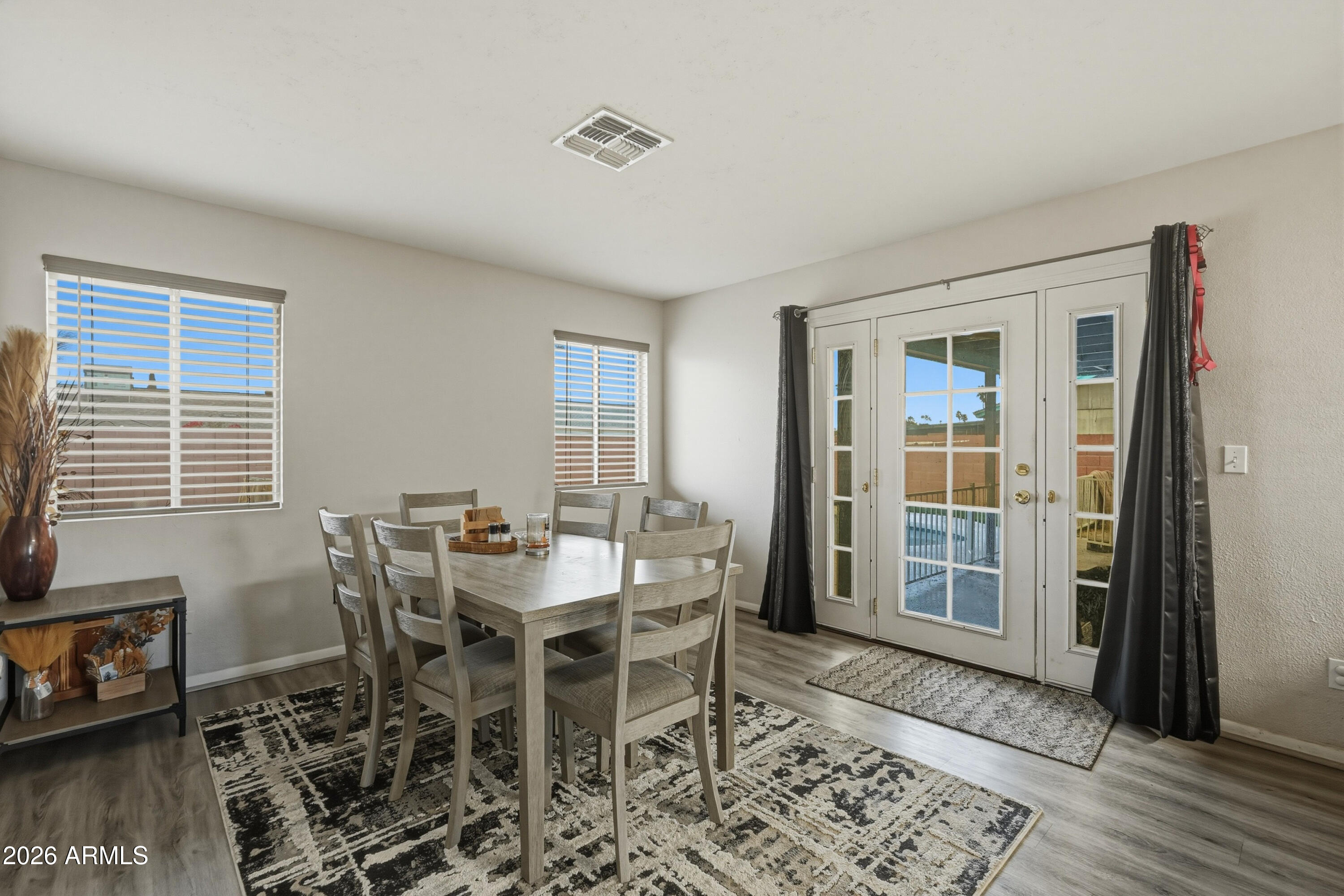 7233 West Hatcher Road Peoria, AZ 85345 - Photo 19 of 36 a view of a dining room with furniture and wooden floor