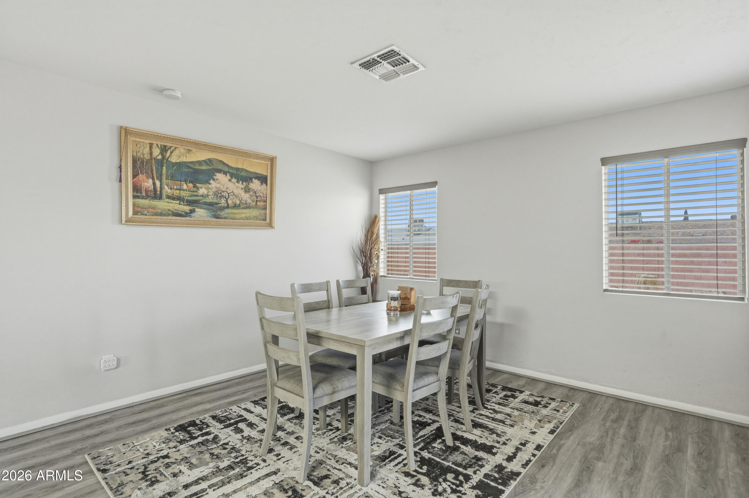 7233 West Hatcher Road Peoria, AZ 85345 - Photo 20 of 36 a view of a dining room with furniture and wooden floor
