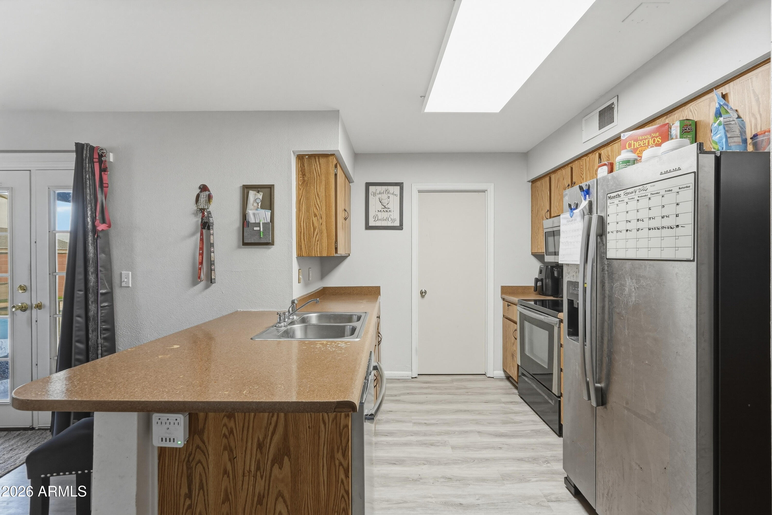 7233 West Hatcher Road Peoria, AZ 85345 - Photo 25 of 36 a kitchen with stainless steel appliances a refrigerator and a stove