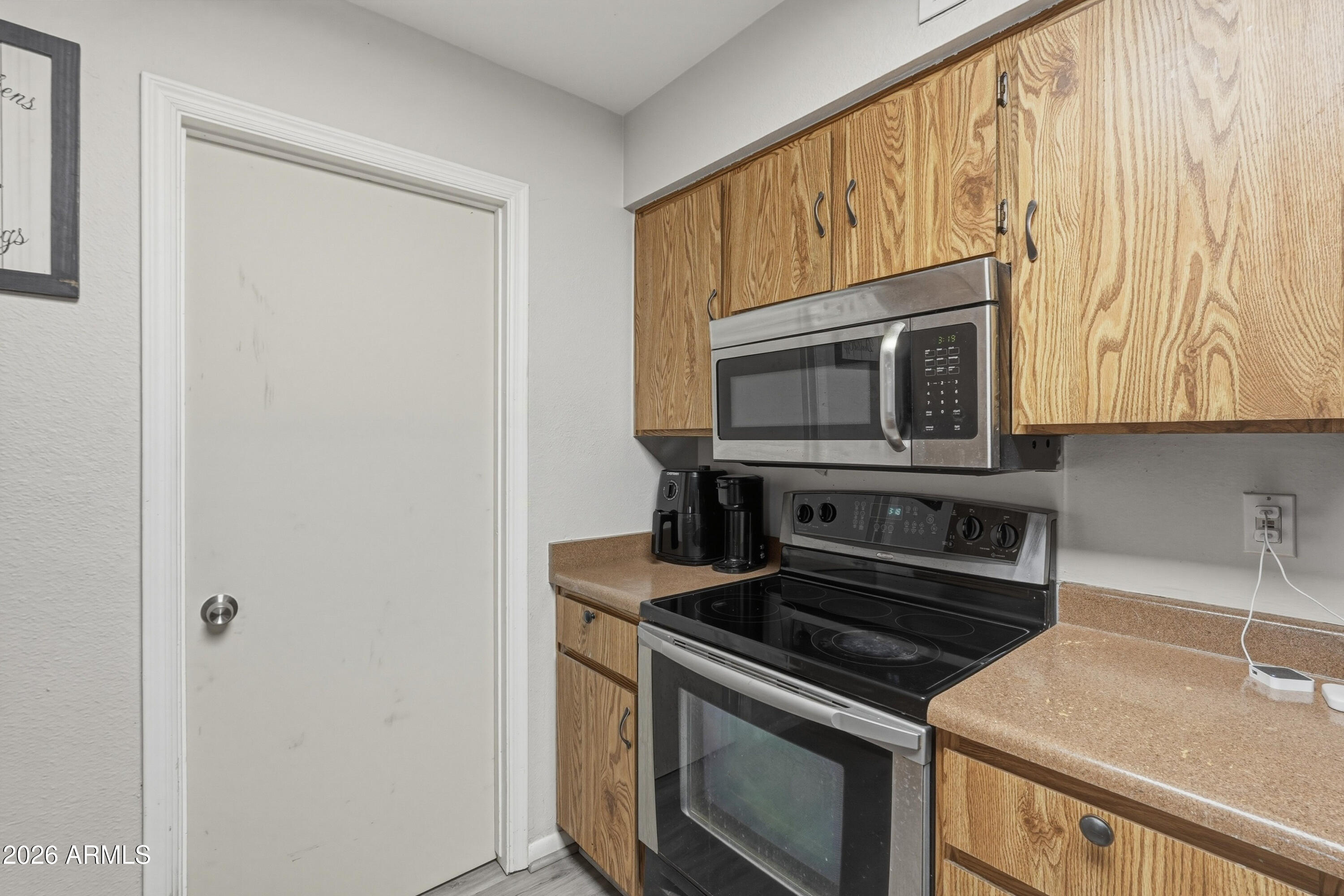 7233 West Hatcher Road Peoria, AZ 85345 - Photo 26 of 36 a kitchen with a stove and a microwave
