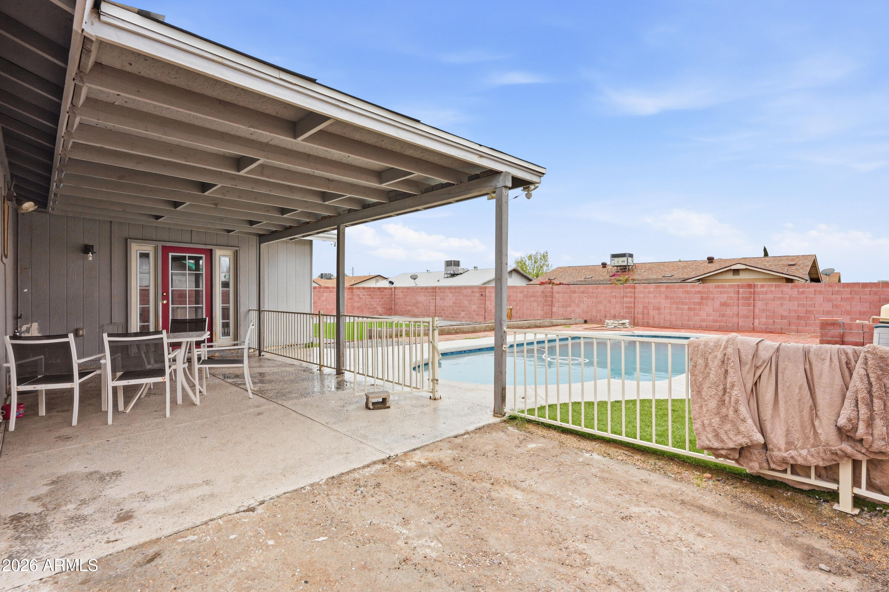 7233 West Hatcher Road Peoria, AZ 85345 - Photo 30 of 36 a view of a backyard with a patio and wooden fence