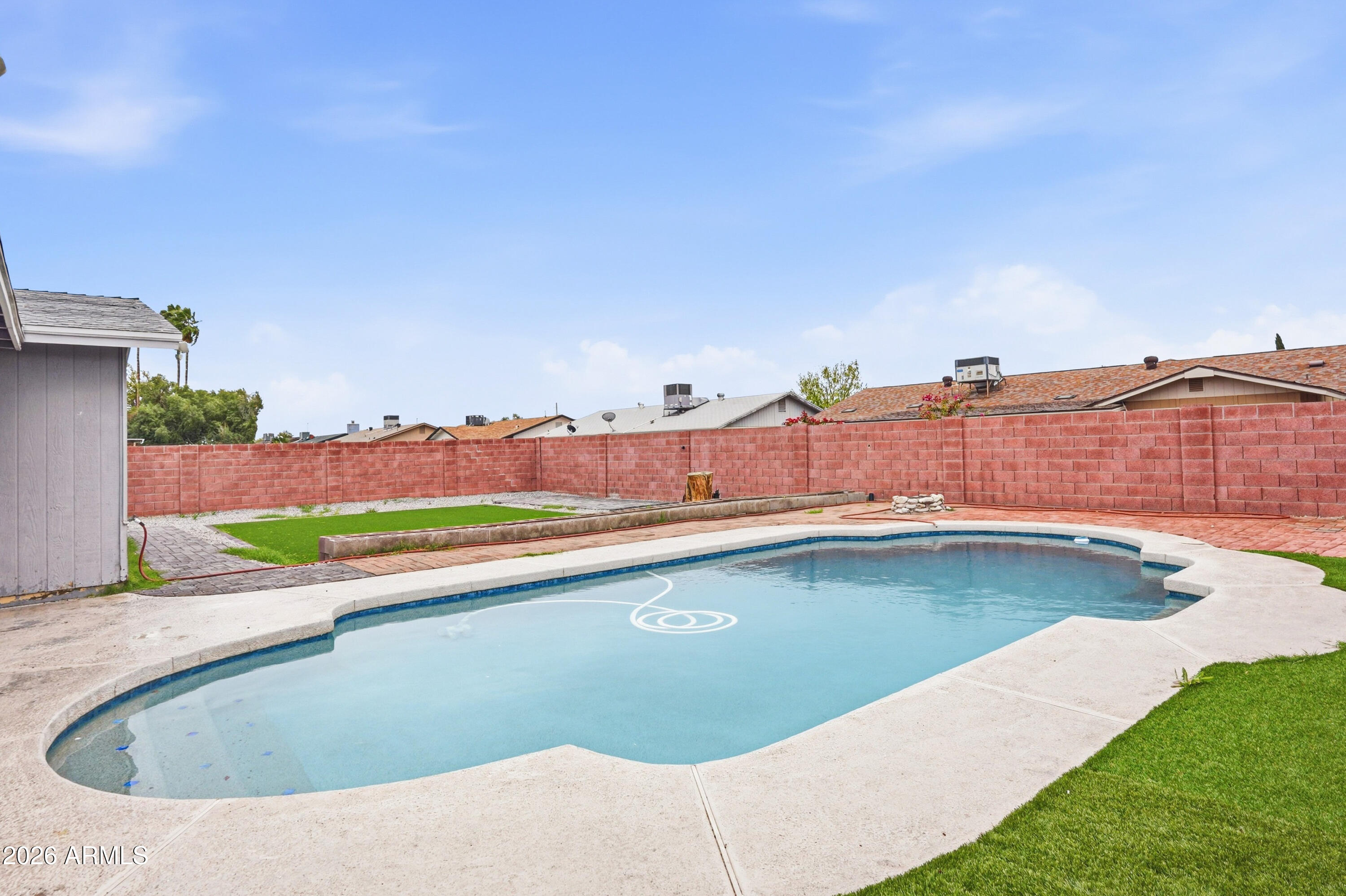 7233 West Hatcher Road Peoria, AZ 85345 - Photo 31 of 36 a view of a swimming pool and mountains in the background
