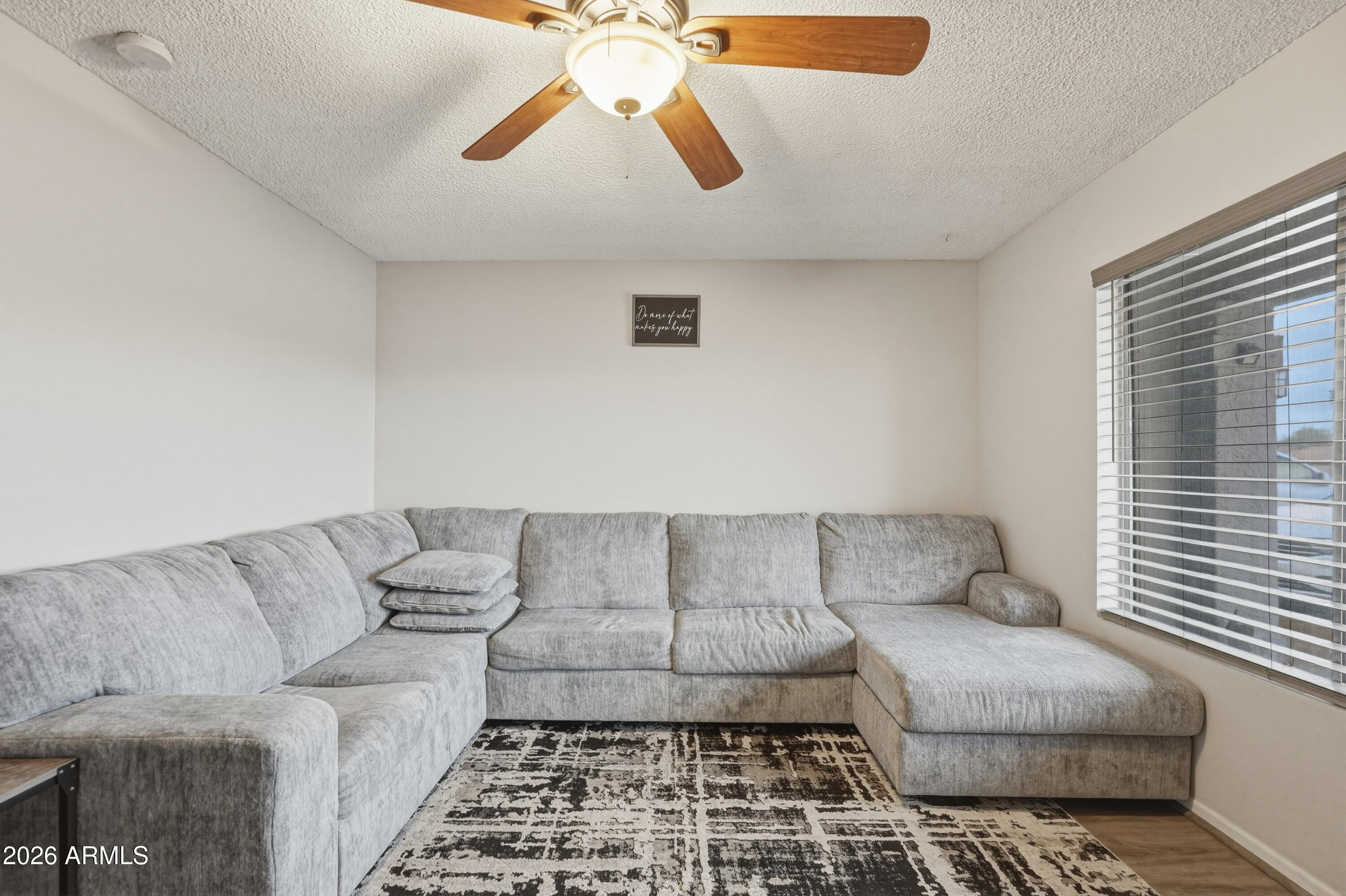 7233 West Hatcher Road Peoria, AZ 85345 - Photo 4 of 36 a living room with furniture and a couch