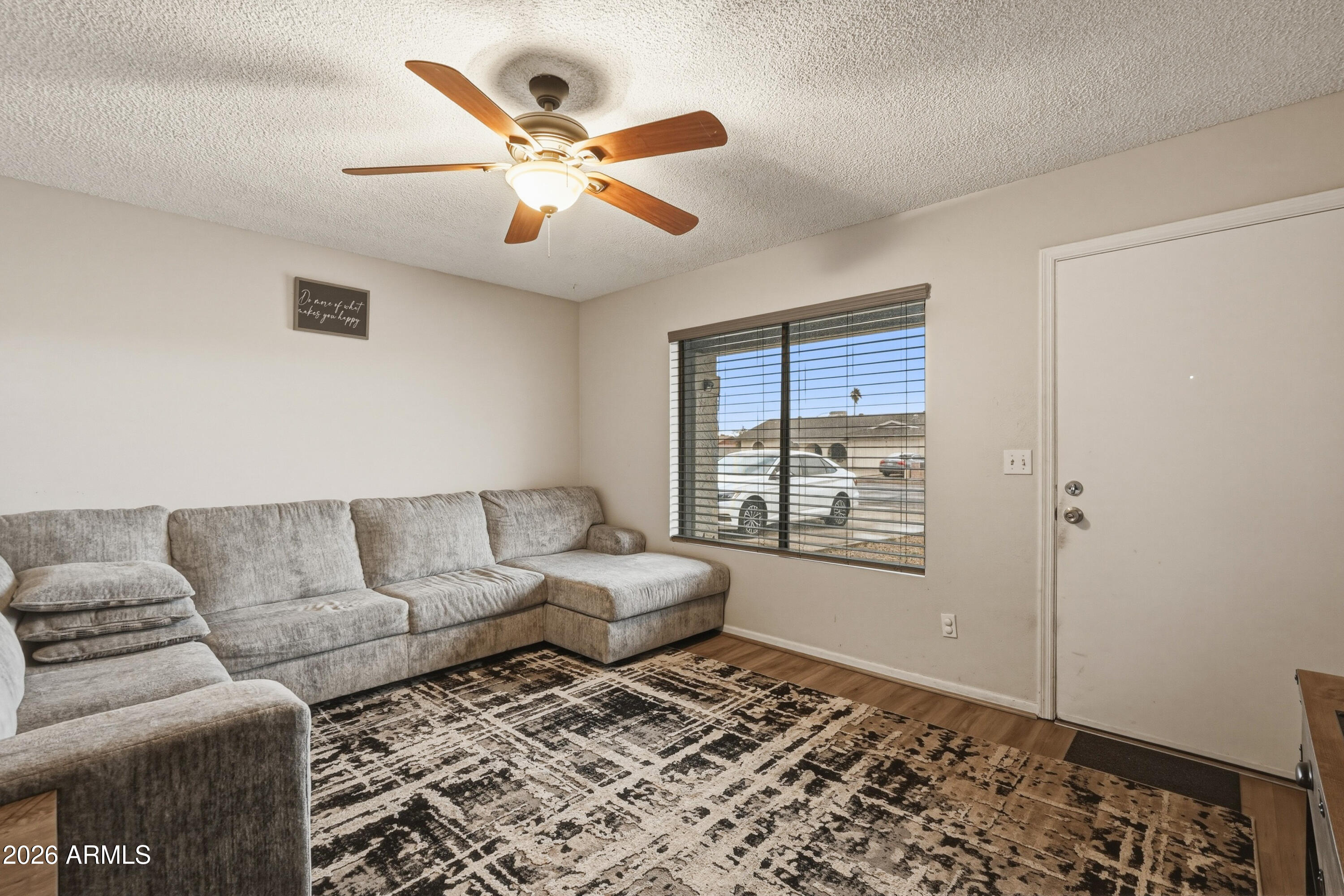 7233 West Hatcher Road Peoria, AZ 85345 - Photo 5 of 36 a living room with furniture and a window