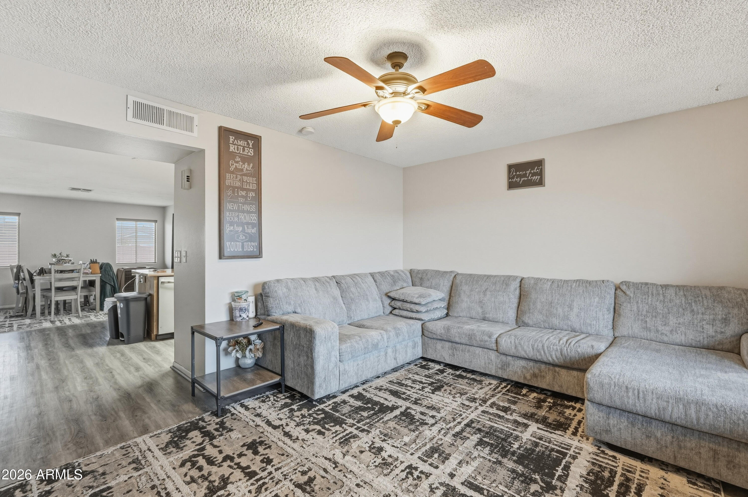 7233 West Hatcher Road Peoria, AZ 85345 - Photo 7 of 36 a living room with furniture and wooden floor
