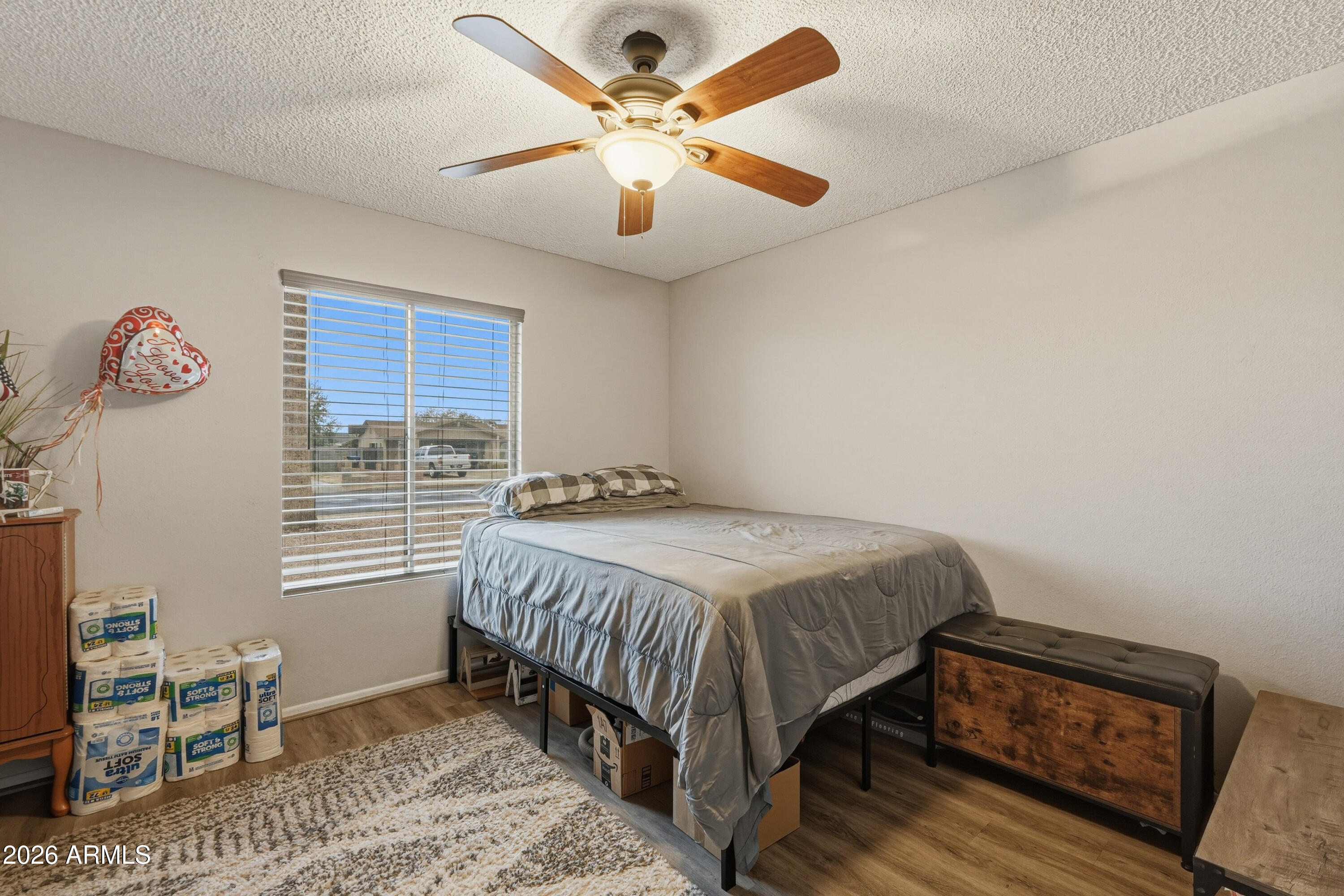 7233 West Hatcher Road Peoria, AZ 85345 - Photo 8 of 36 a bedroom with a bed and a chandelier