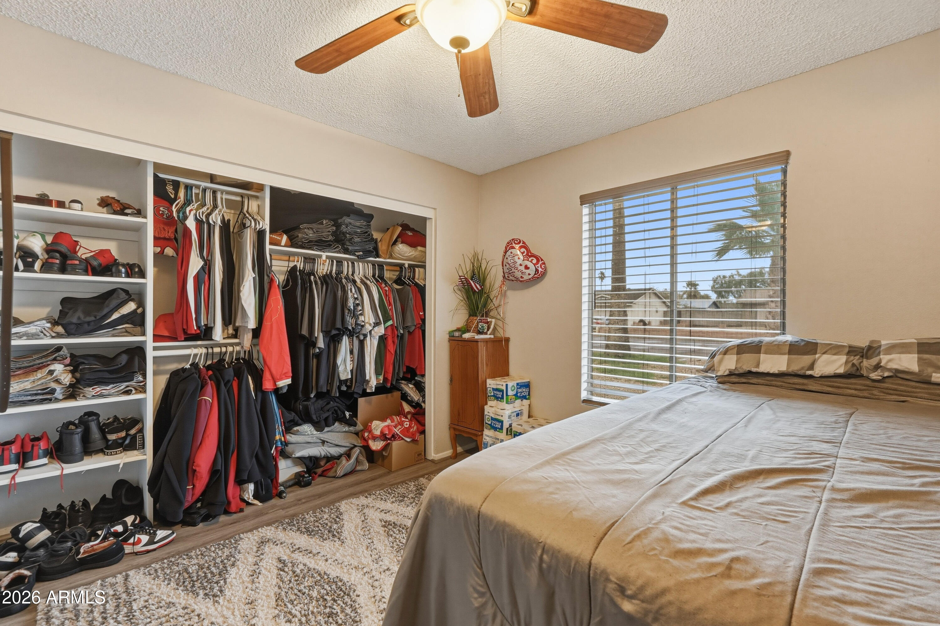 7233 West Hatcher Road Peoria, AZ 85345 - Photo 9 of 36 a bedroom with a bed and a window