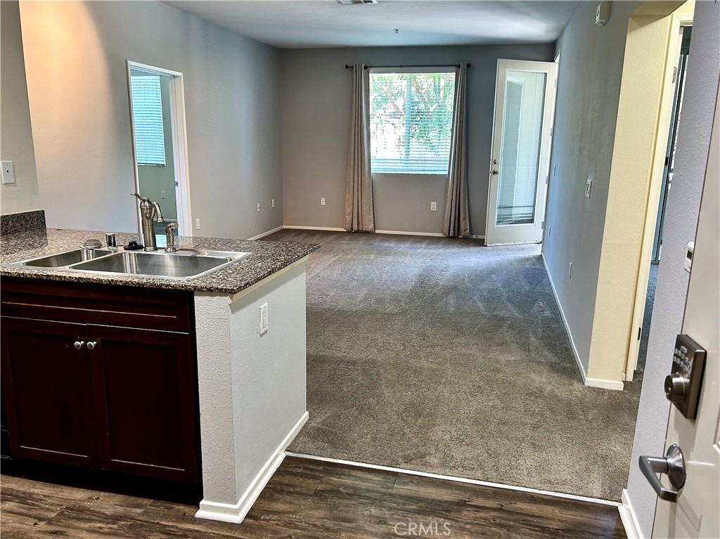 a bathroom with a granite countertop sink a mirror and a bathtub