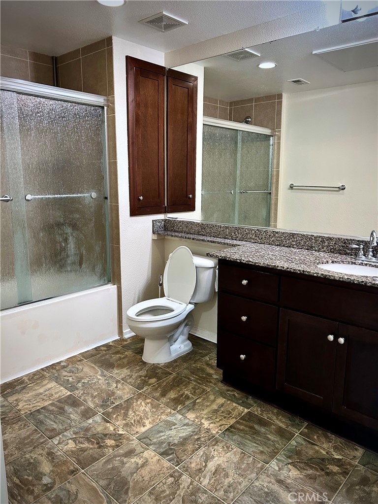1326 Scholarship Irvine, CA 92612 - Photo 13 of 27 a spacious bathroom with a granite countertop sink toilet and mirror