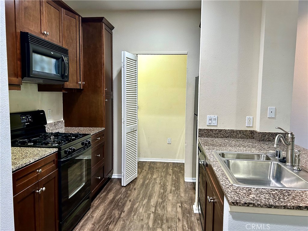 1326 Scholarship Irvine, CA 92612 - Photo 2 of 27 a kitchen with stainless steel appliances granite countertop a stove a sink and a microwave