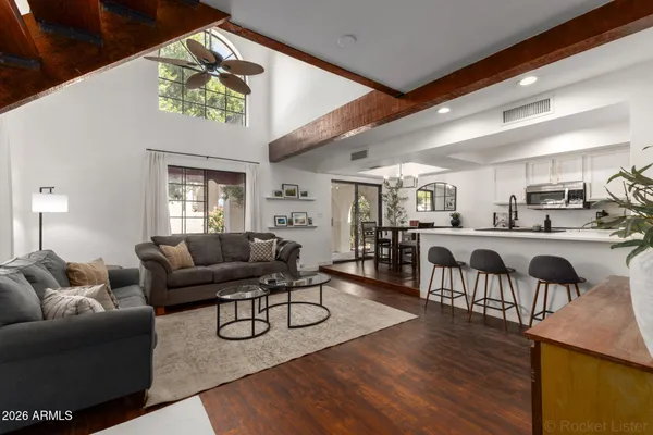 a living room with furniture and a wooden floor