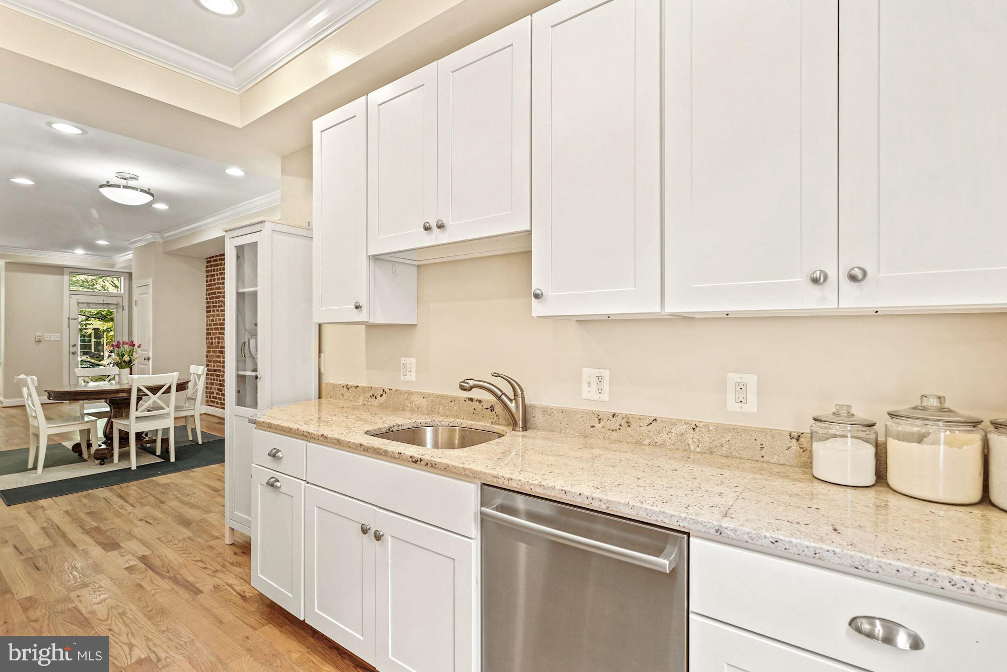 832 5th Street Northeast Washington, DC 20002 - Photo 11 of 35 a kitchen with granite countertop a sink a stove and cabinets
