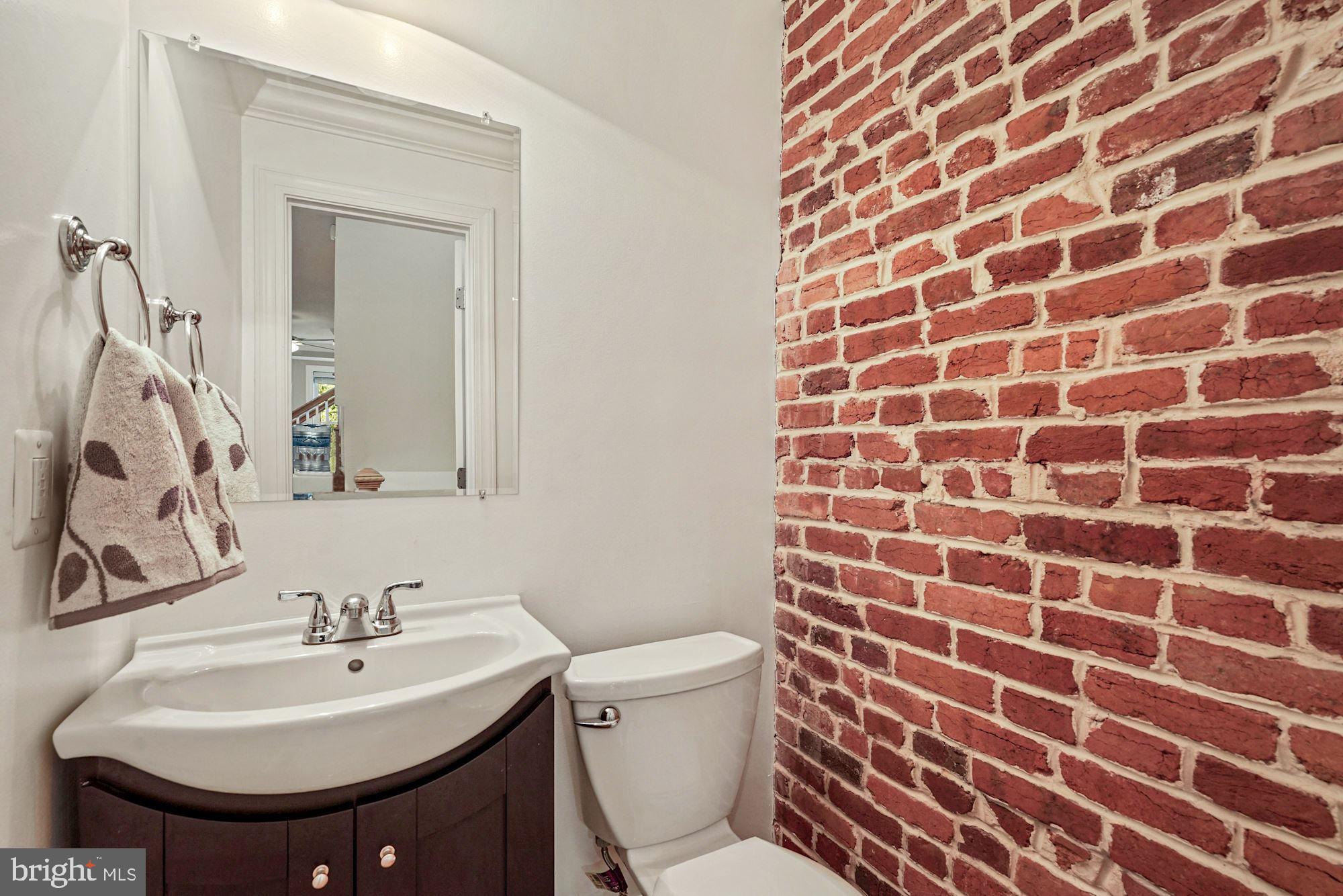 832 5th Street Northeast Washington, DC 20002 - Photo 12 of 35 a bathroom with a sink toilet and mirror