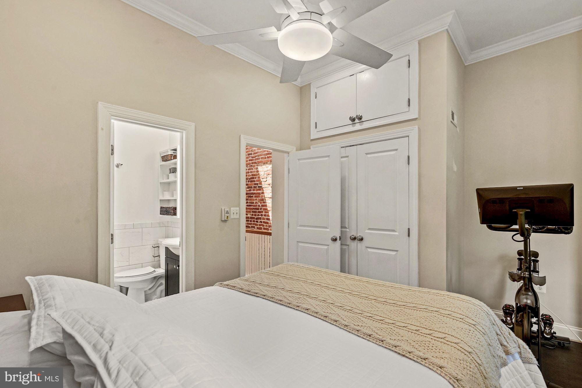 832 5th Street Northeast Washington, DC 20002 - Photo 17 of 35 a bedroom with a bed and a chandelier