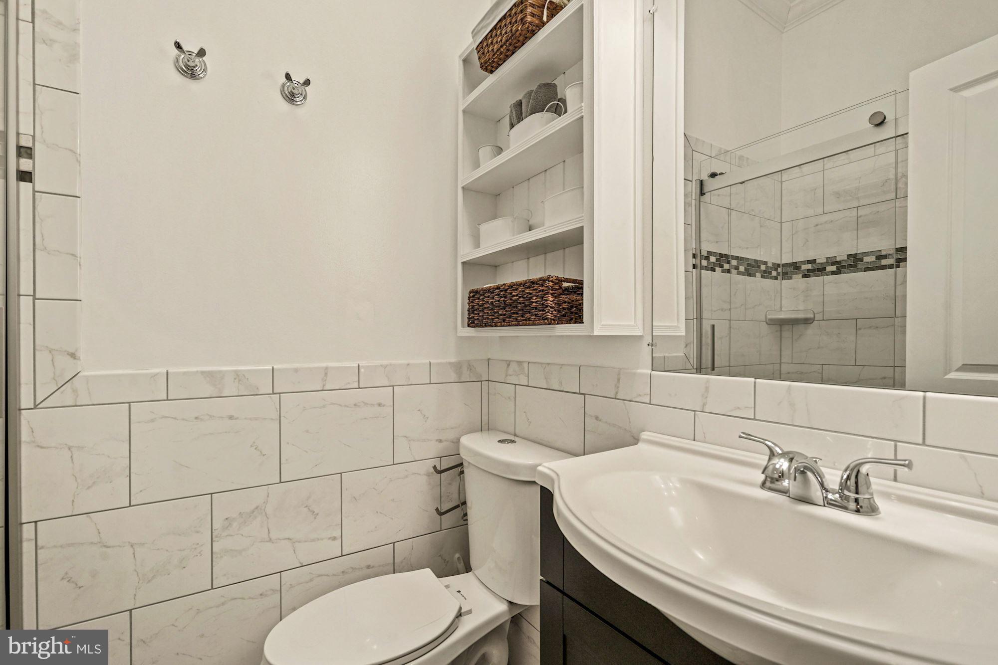 832 5th Street Northeast Washington, DC 20002 - Photo 20 of 35 a bathroom with a sink toilet and shower