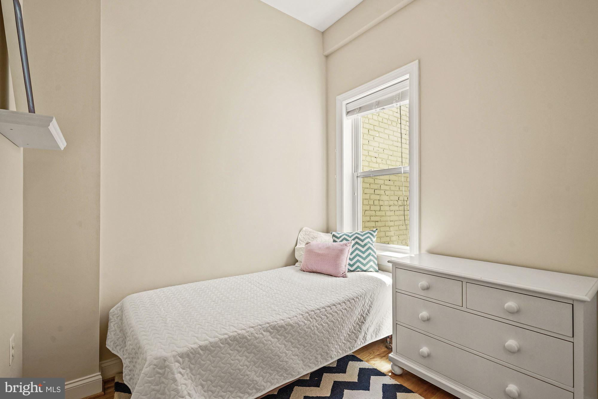 832 5th Street Northeast Washington, DC 20002 - Photo 21 of 35 a bedroom with a bed and window