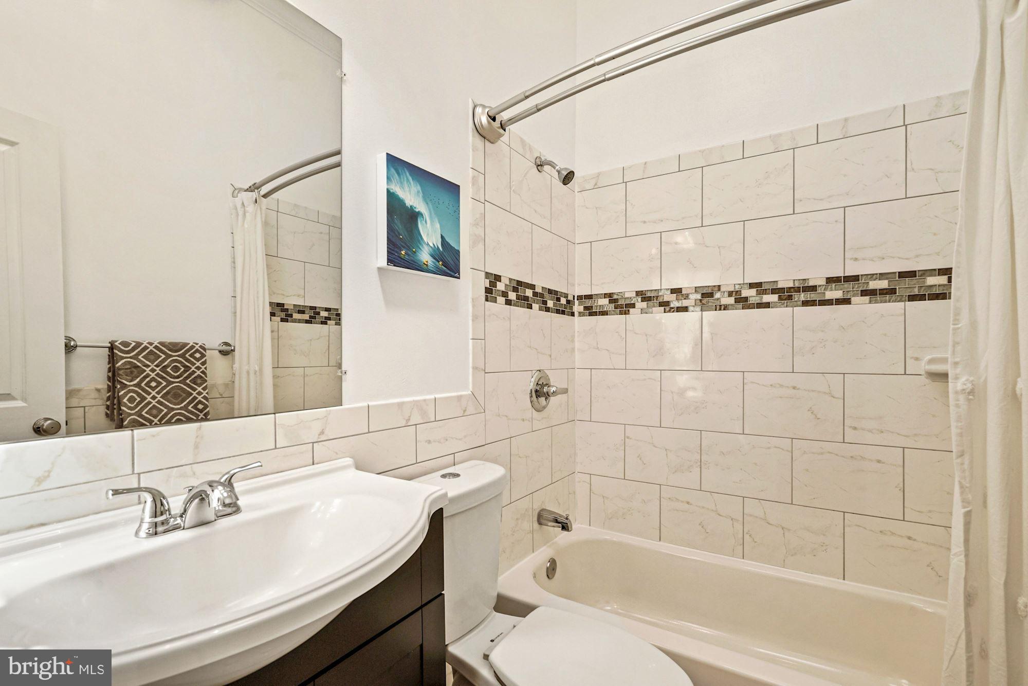 832 5th Street Northeast Washington, DC 20002 - Photo 23 of 35 a bathroom with a sink shower and a bathtub