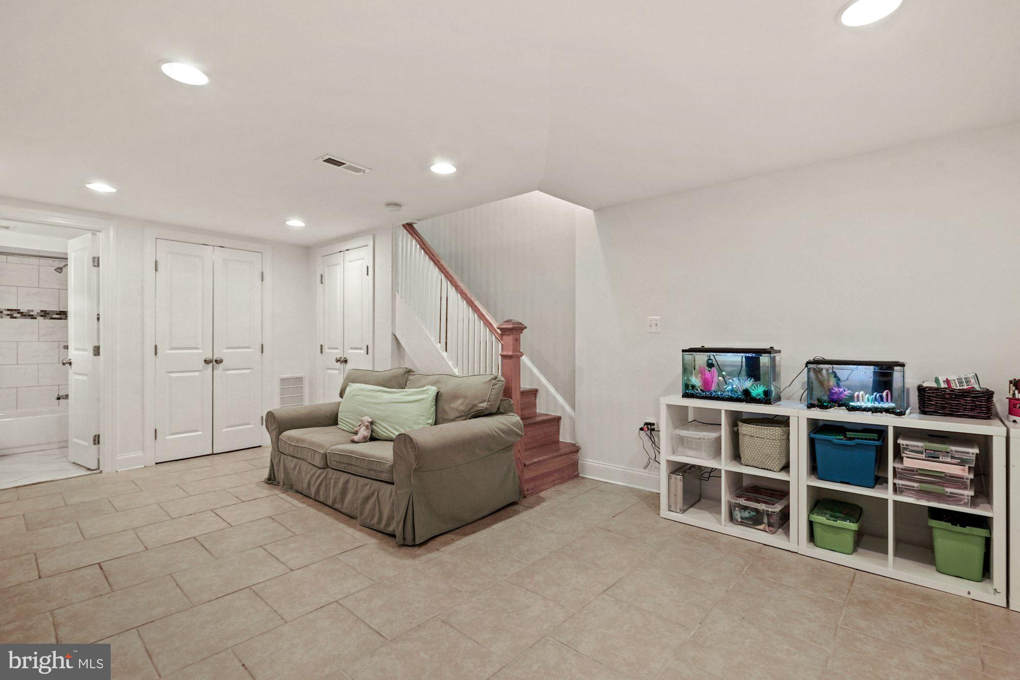 832 5th Street Northeast Washington, DC 20002 - Photo 24 of 35 a living room with furniture and a book shelf