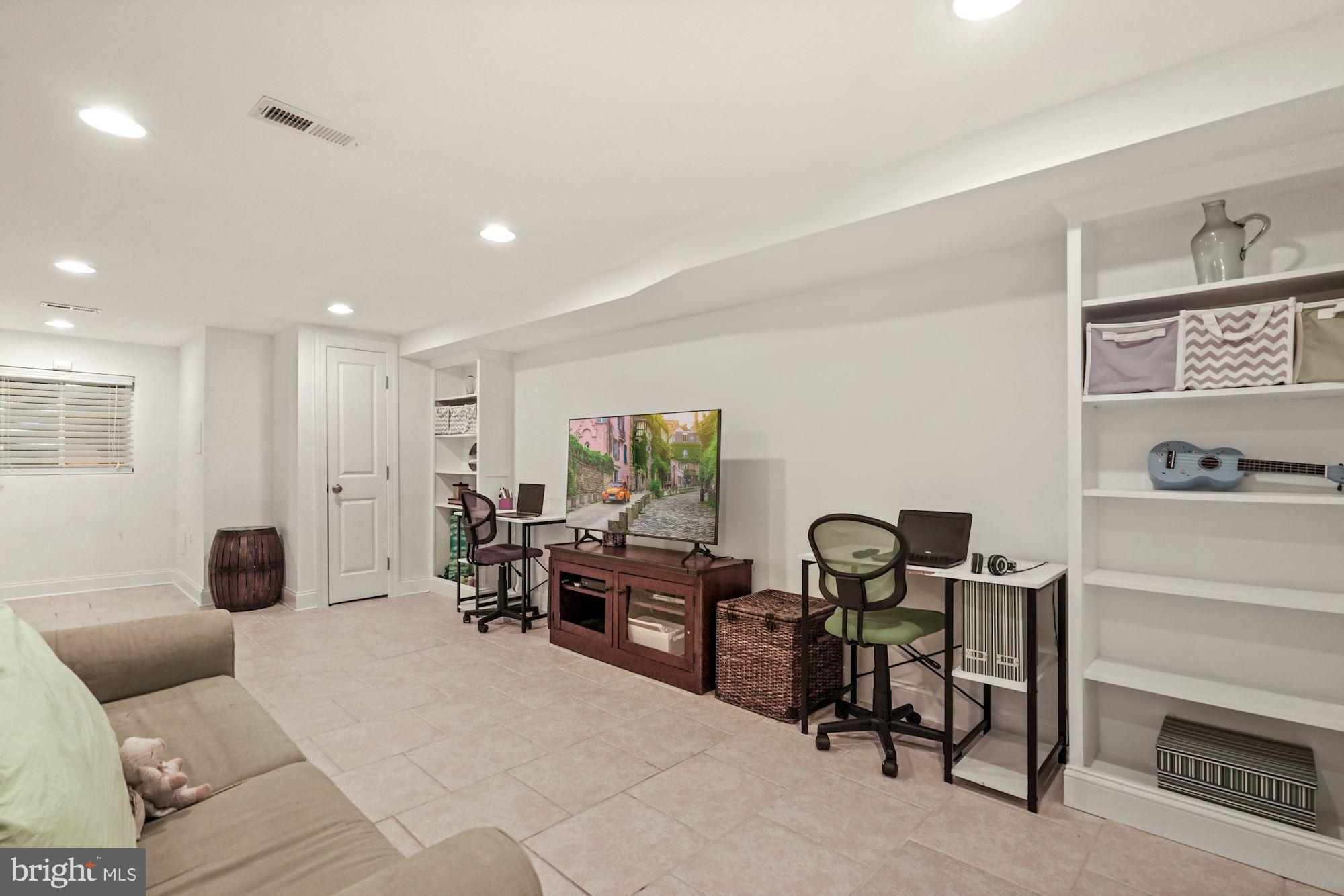 832 5th Street Northeast Washington, DC 20002 - Photo 25 of 35 a living room with furniture and a flat screen tv