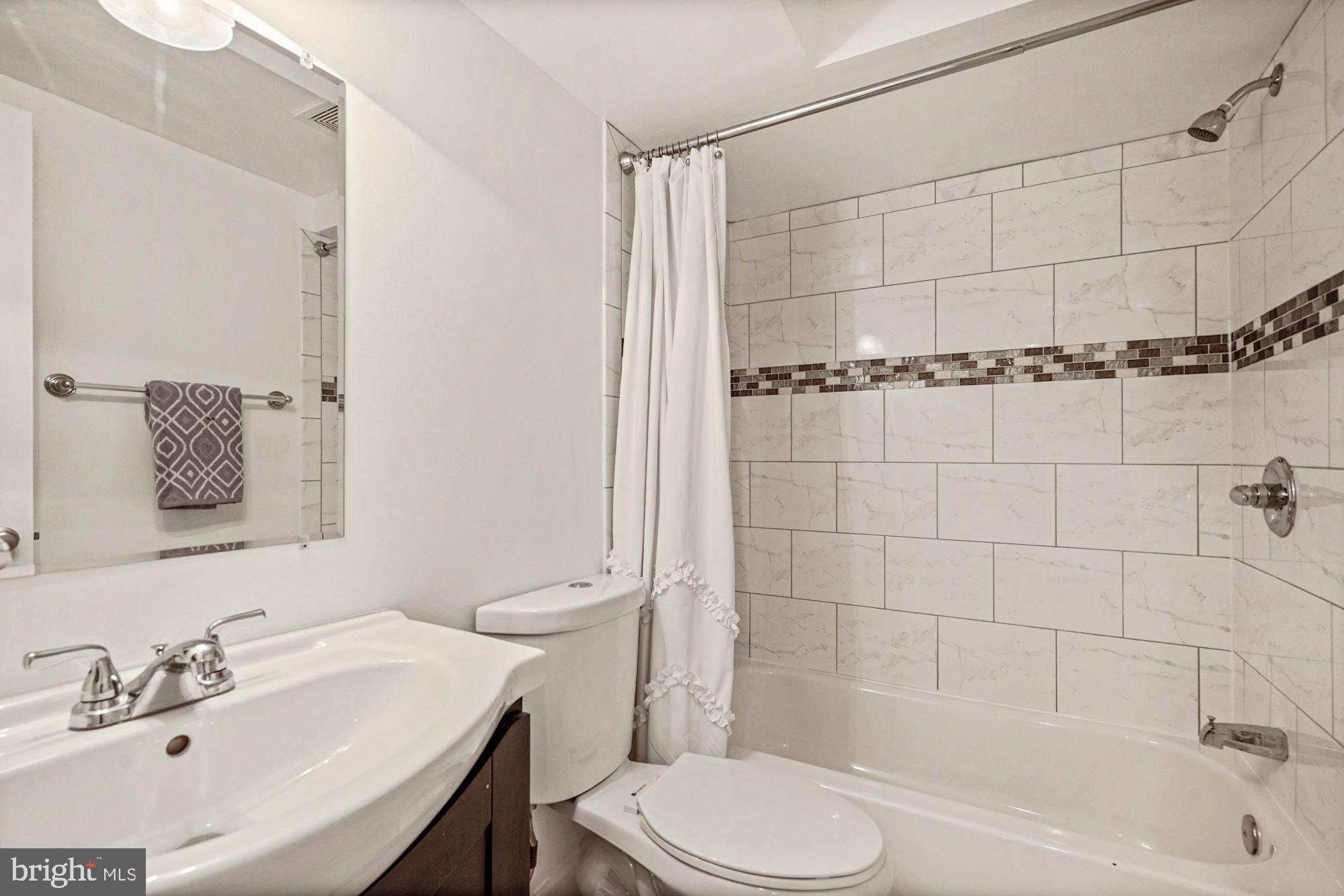 832 5th Street Northeast Washington, DC 20002 - Photo 29 of 35 a bathroom with a sink toilet and shower