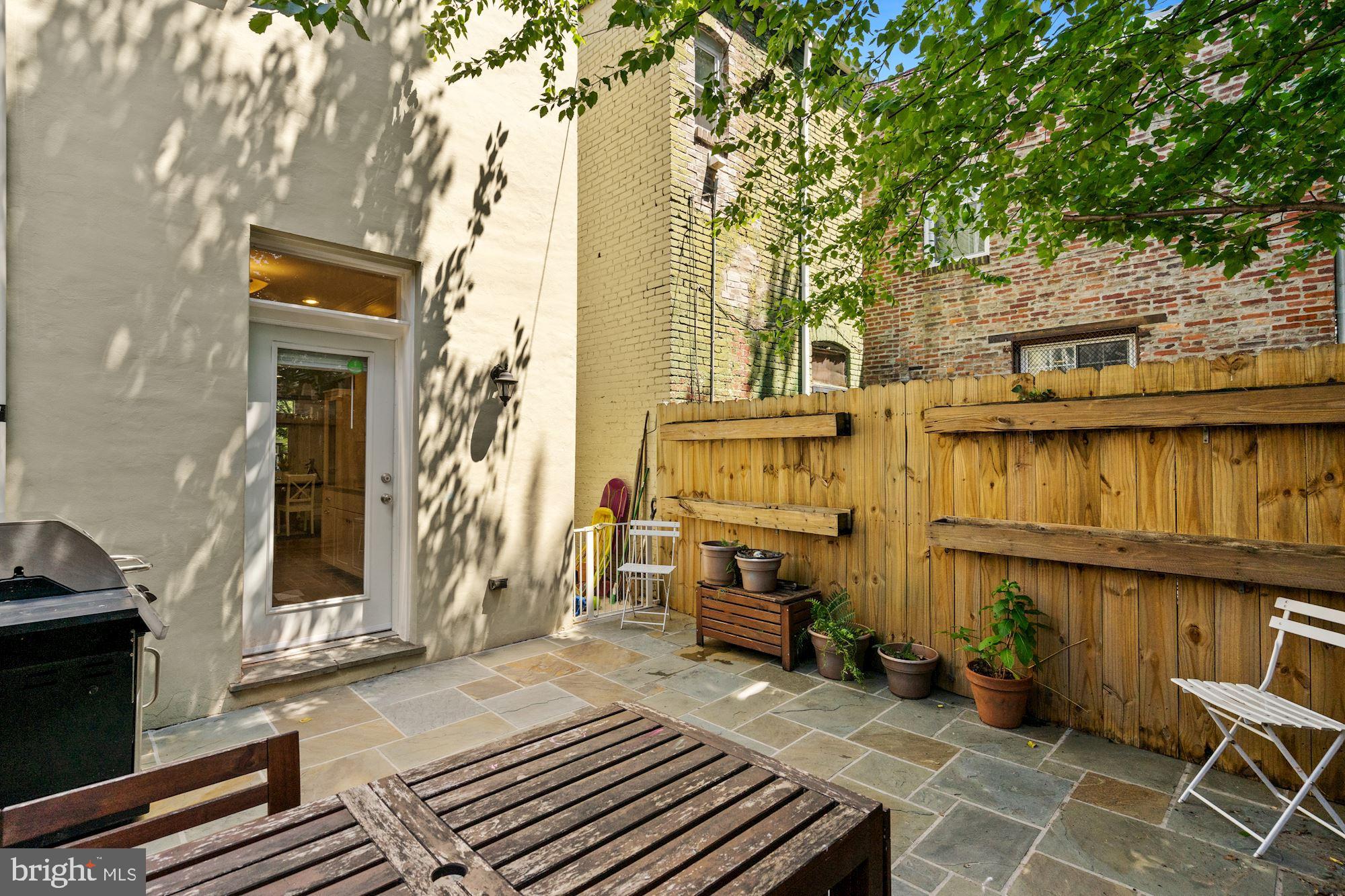 832 5th Street Northeast Washington, DC 20002 - Photo 32 of 35 a view of a patio with table and chairs with wooden floor and fence