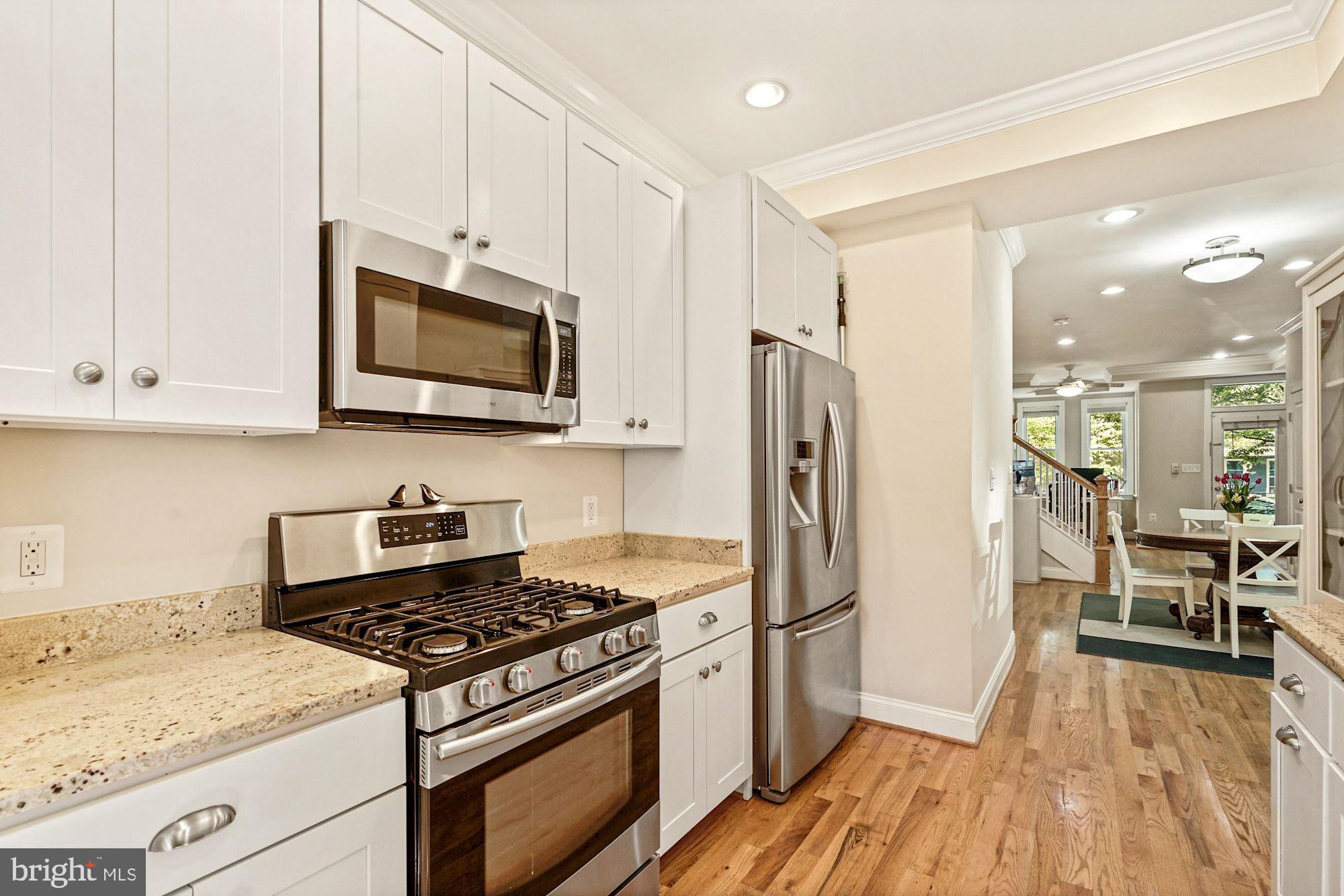 832 5th Street Northeast Washington, DC 20002 - Photo 9 of 35 a kitchen with stainless steel appliances granite countertop a stove a refrigerator and a microwave