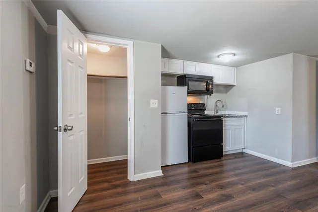 a kitchen with a refrigerator and a sink