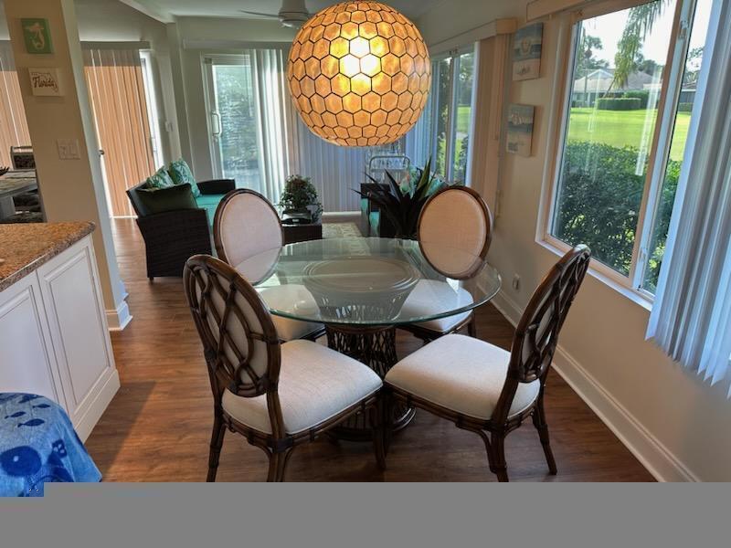 17042 Traverse Circle Jupiter, FL 33477 - Photo 13 of 30 a view of a dining room with furniture and a large window