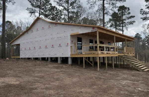 a view of a house with a yard and sitting area