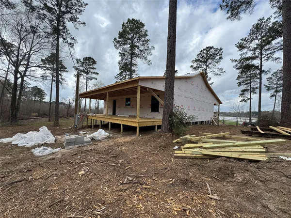 a view of a house with a yard covered in snow