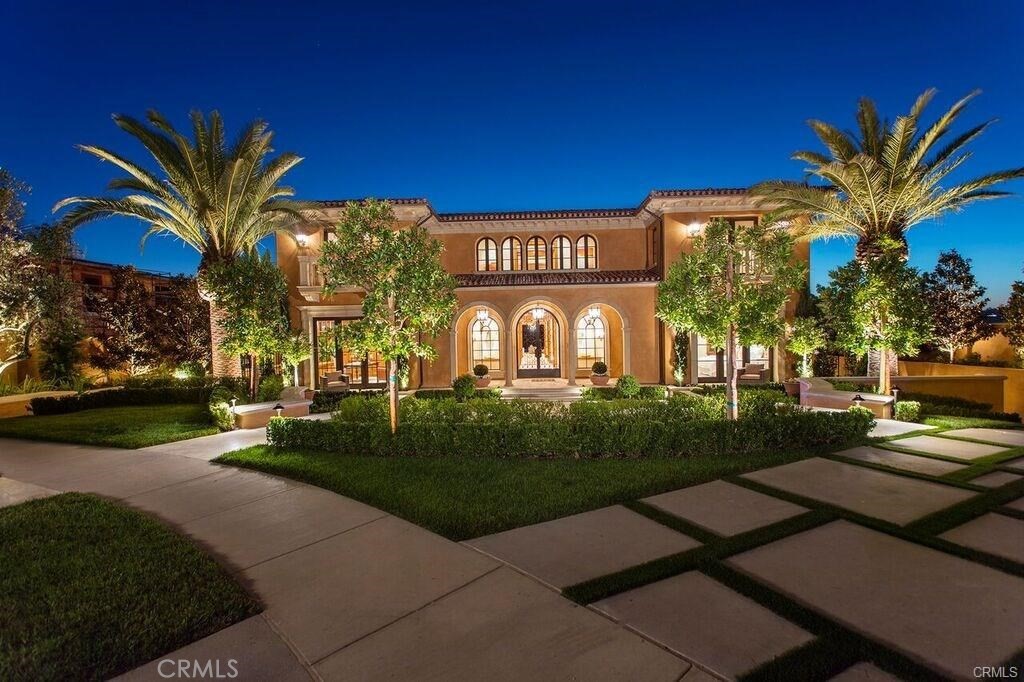 a front view of a house with a garden and a yard
